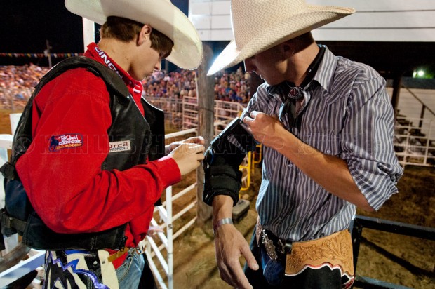 Bull riders helping each other out at the Shady Dale Rodeo.